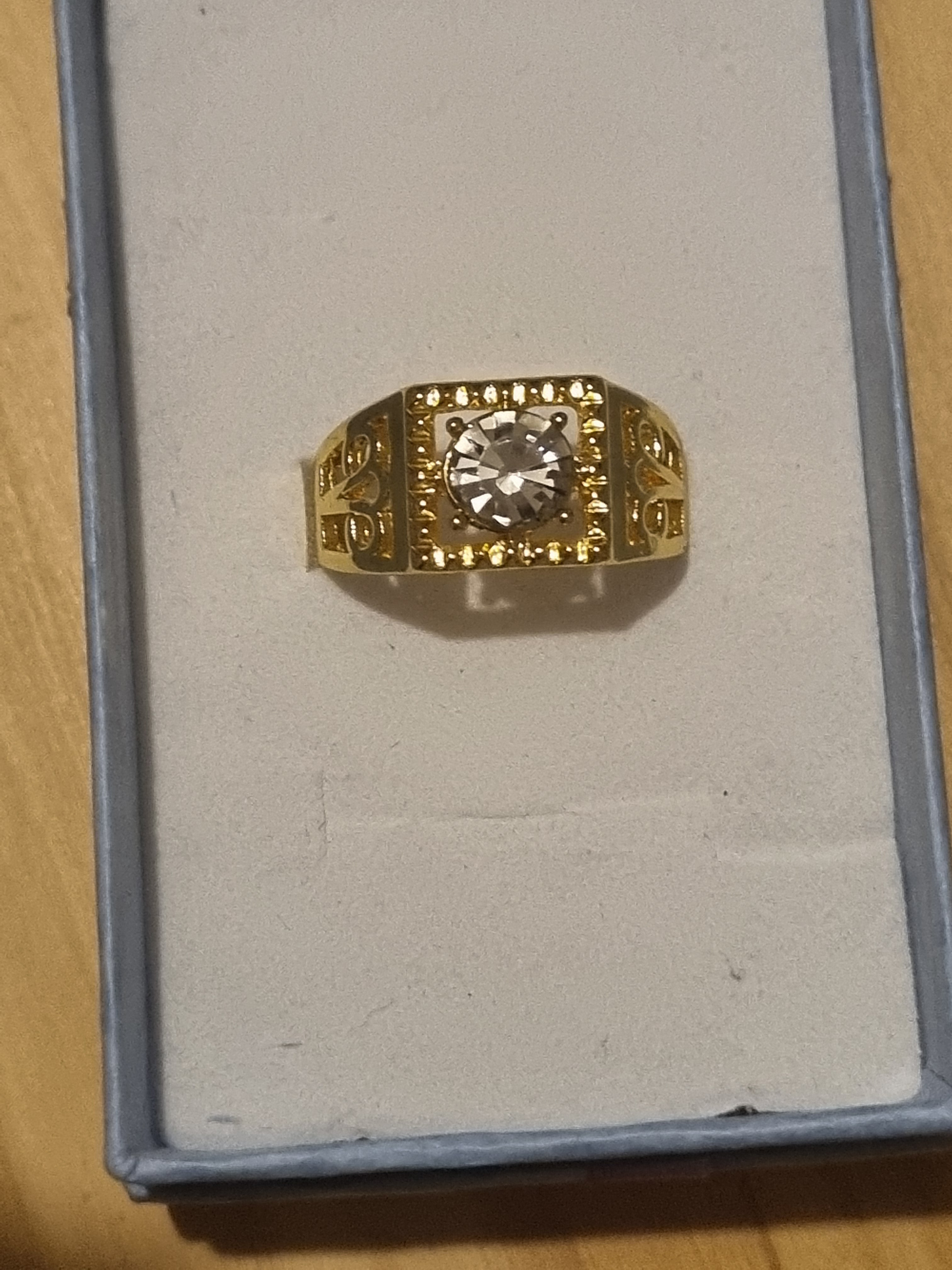 Mens stainless steel golden ring with beautifully designed setting.
