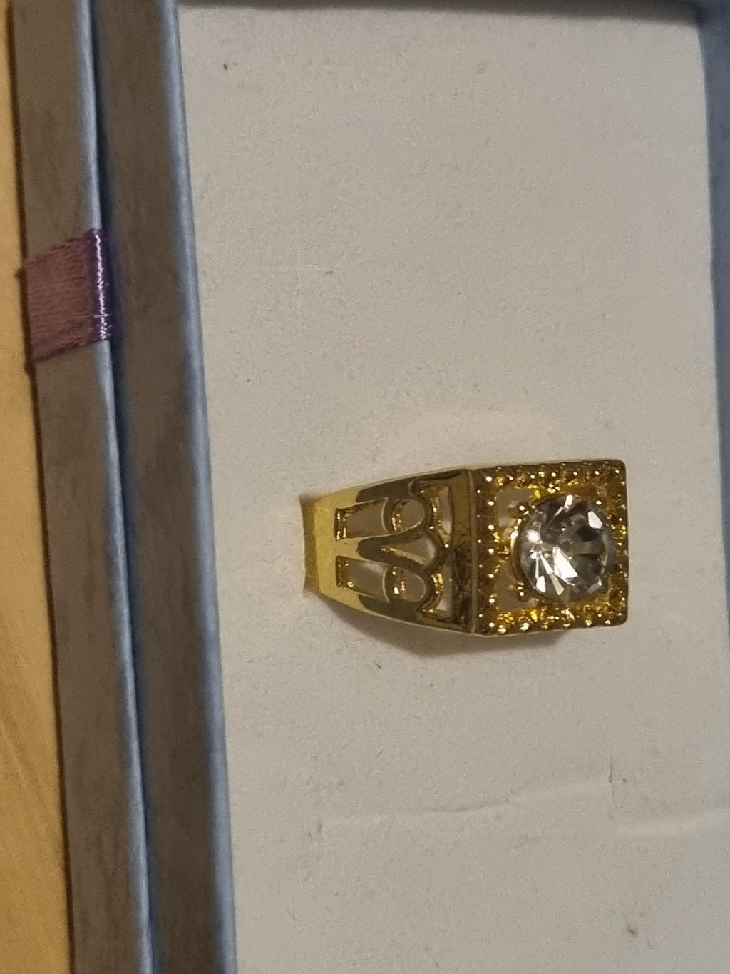 Mens stainless steel golden ring with beautifully designed setting.