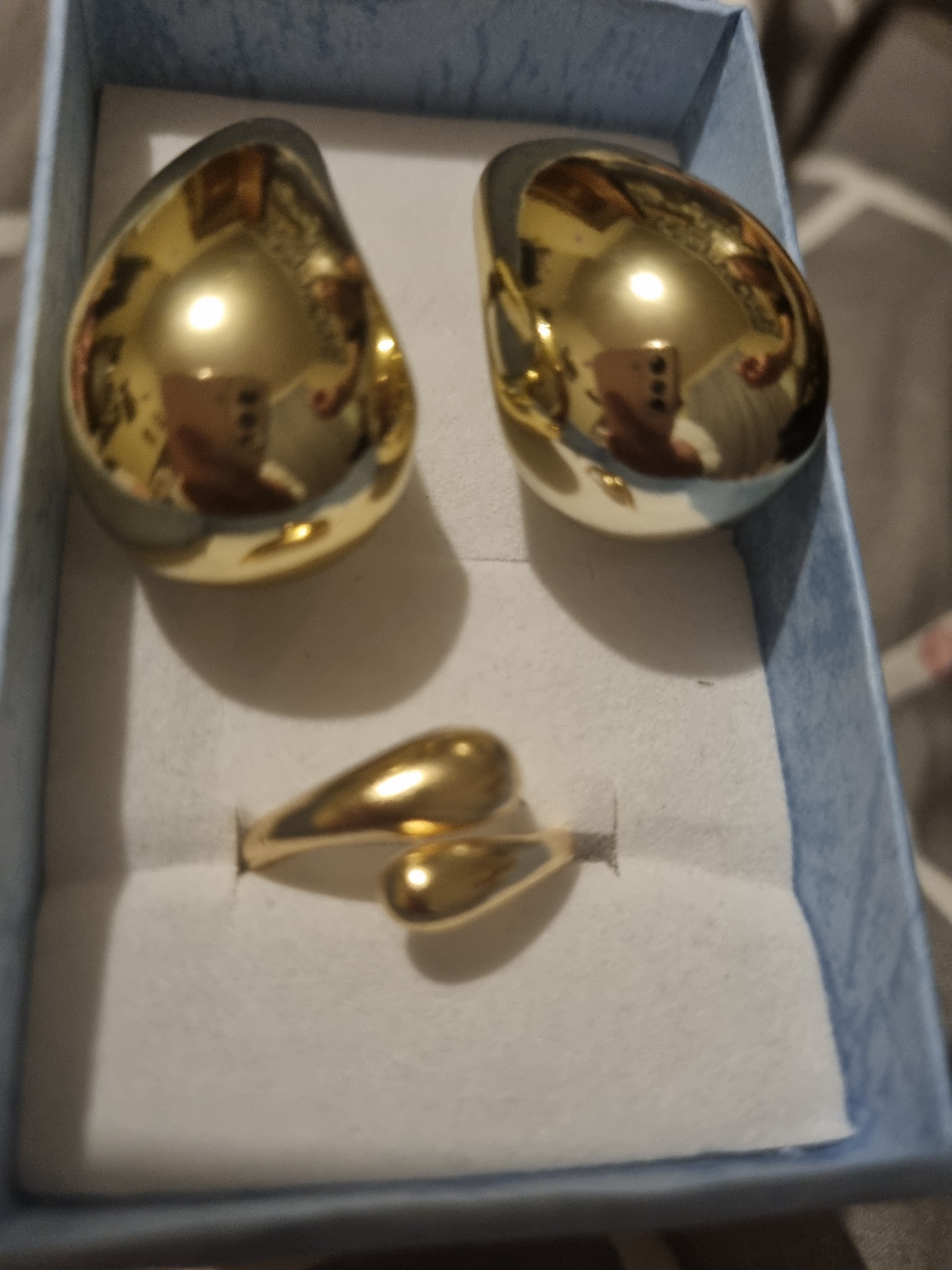 Beautifully designed ladies gold set tear drop earrings and a golden Beautifully designed ladies ring.