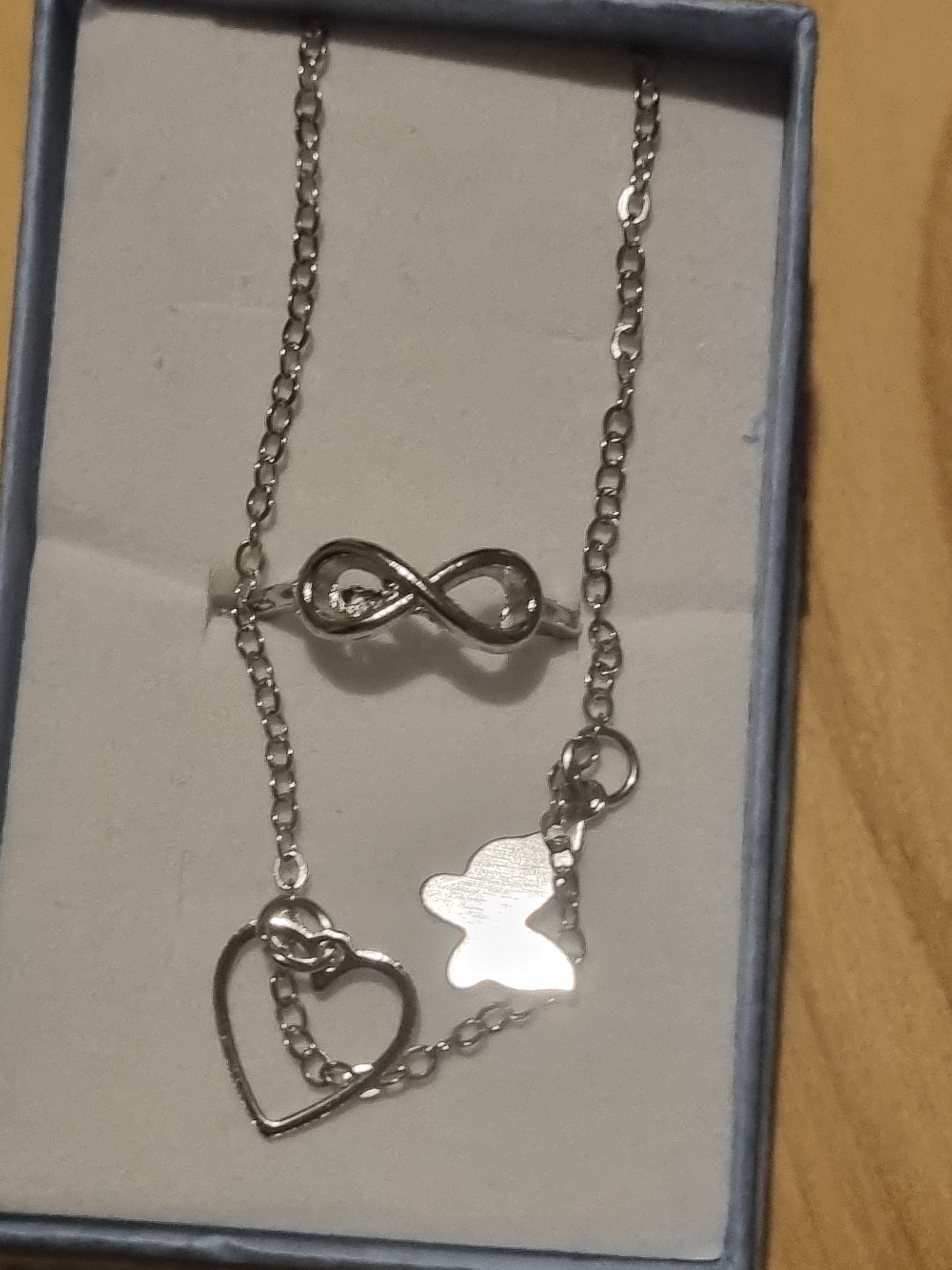 Beautiful butterfly braclet and a figure eight style designed ladies silver ring.