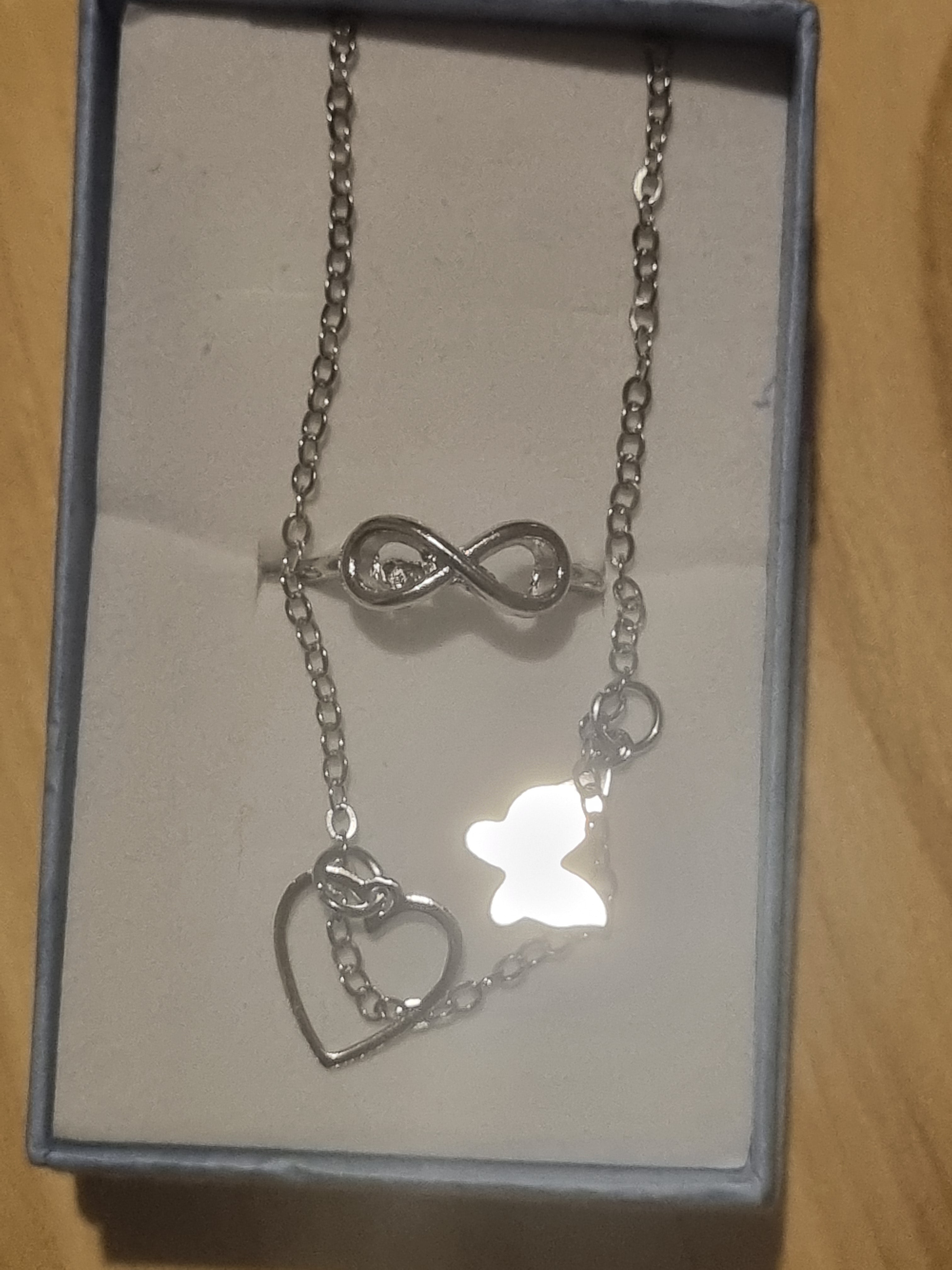 Beautiful butterfly braclet and a figure eight style designed ladies silver ring.