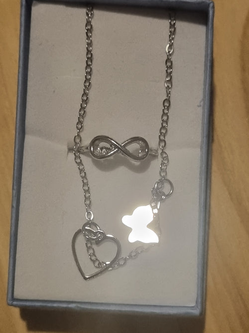 Beautiful butterfly braclet and a figure eight style designed ladies silver ring.
